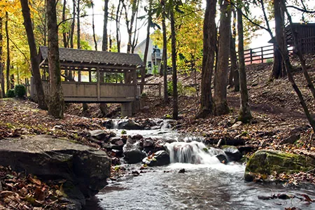 The covered bridge over the creek in autumn